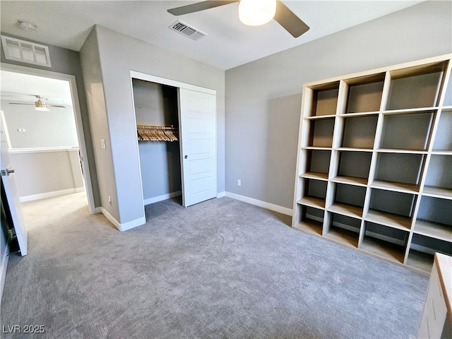 unfurnished bedroom with carpet, a closet, and ceiling fan