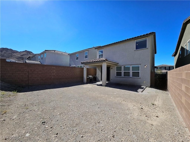 rear view of property featuring a patio