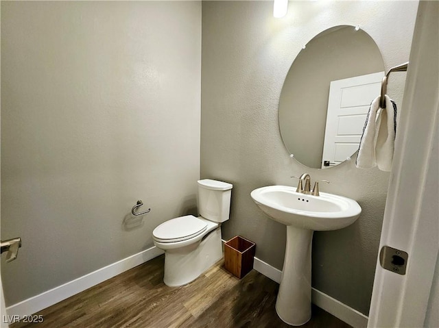 bathroom featuring hardwood / wood-style floors, toilet, and sink