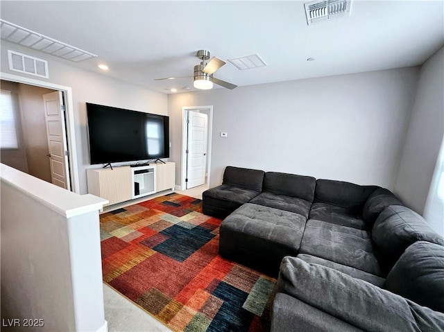 living room with ceiling fan and carpet floors