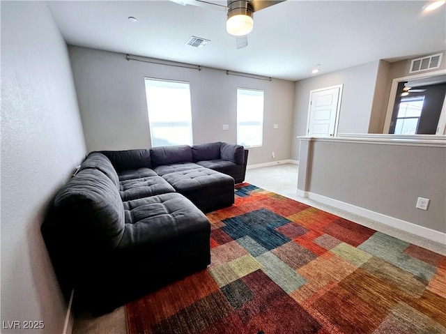 carpeted living room with ceiling fan