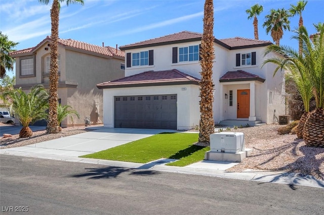 mediterranean / spanish house with central air condition unit and a garage