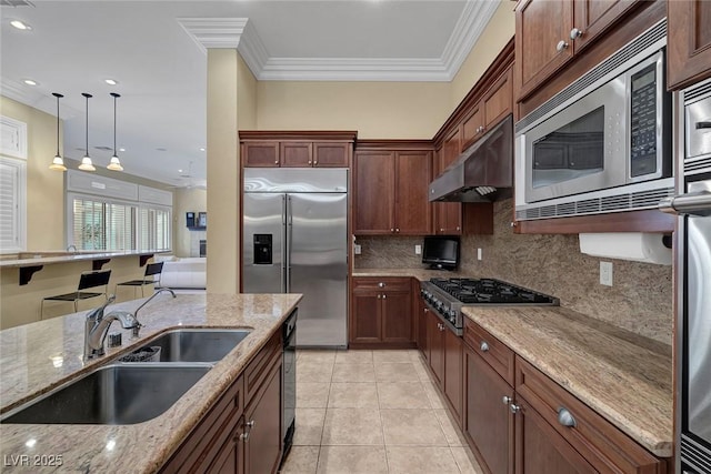 kitchen with light stone counters, crown molding, sink, light tile patterned floors, and built in appliances