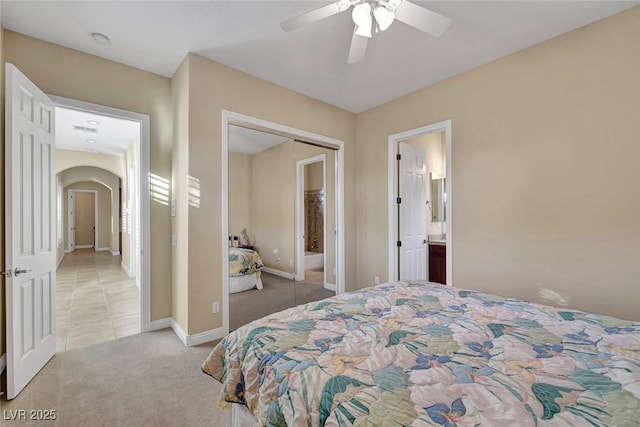 carpeted bedroom with ceiling fan and a closet