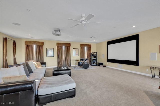 carpeted home theater room featuring ceiling fan