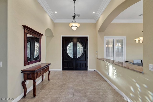 tiled entryway with french doors and ornamental molding