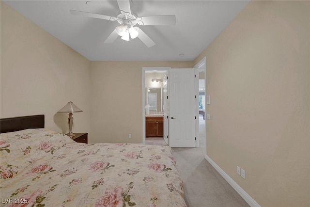 carpeted bedroom with ceiling fan and ensuite bathroom