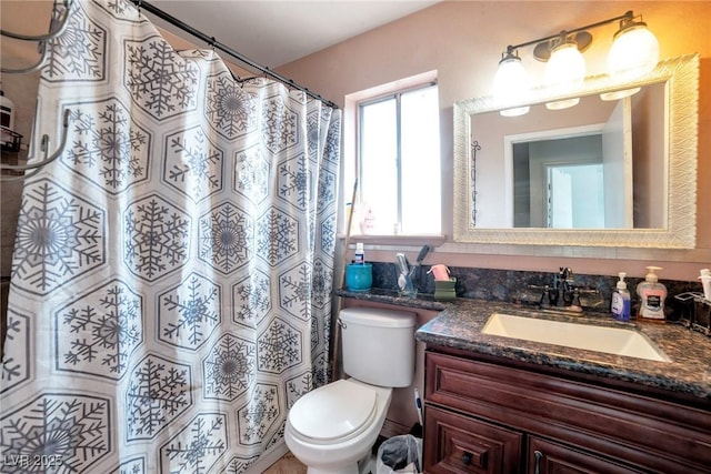 bathroom with vanity, toilet, and walk in shower