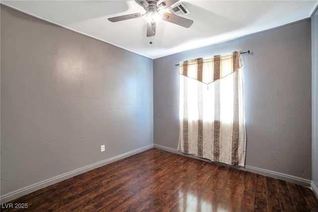 empty room with ceiling fan and dark wood-type flooring