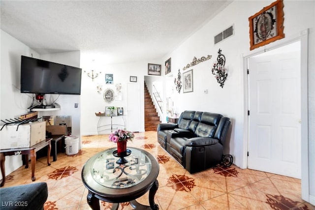 living room featuring tile patterned floors, lofted ceiling, and a textured ceiling