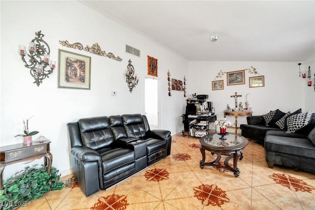 living room featuring vaulted ceiling and tile patterned floors