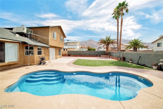 view of pool with central air condition unit, a mountain view, and a patio