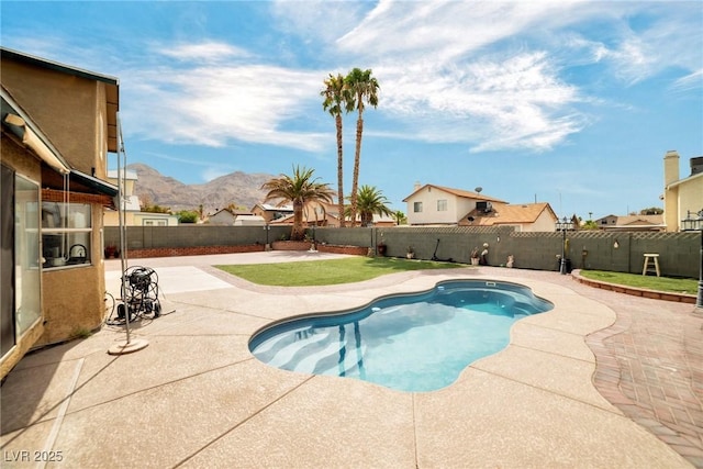 view of pool with a mountain view and a patio