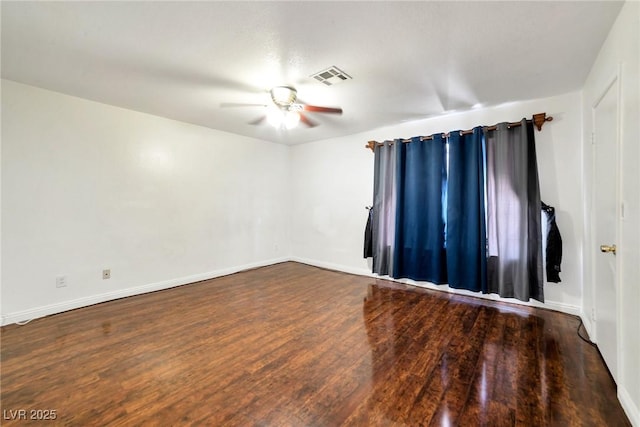 empty room featuring dark hardwood / wood-style flooring and ceiling fan