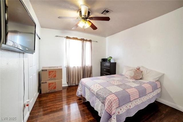 bedroom featuring ceiling fan and dark hardwood / wood-style floors