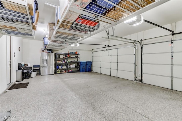 garage featuring stainless steel fridge and a garage door opener