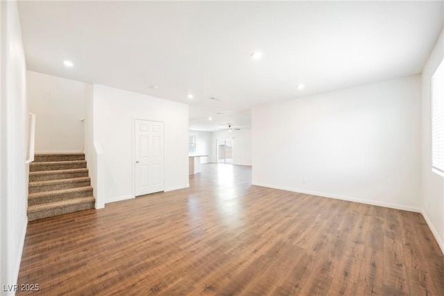 unfurnished living room with hardwood / wood-style flooring and ceiling fan