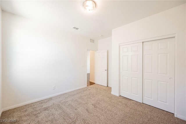 unfurnished bedroom featuring carpet floors and a closet