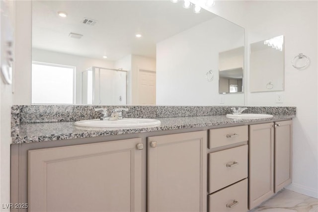 bathroom featuring vanity and a shower with shower door