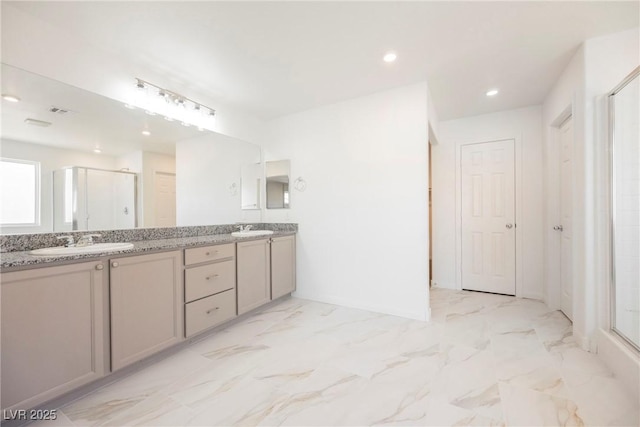 bathroom with vanity and a shower with shower door