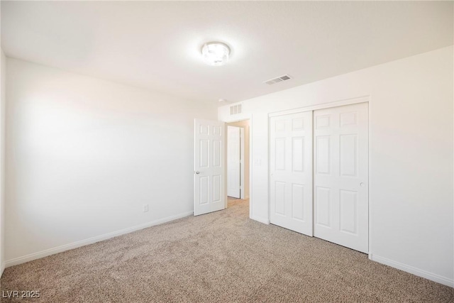 unfurnished bedroom with carpet floors and a closet