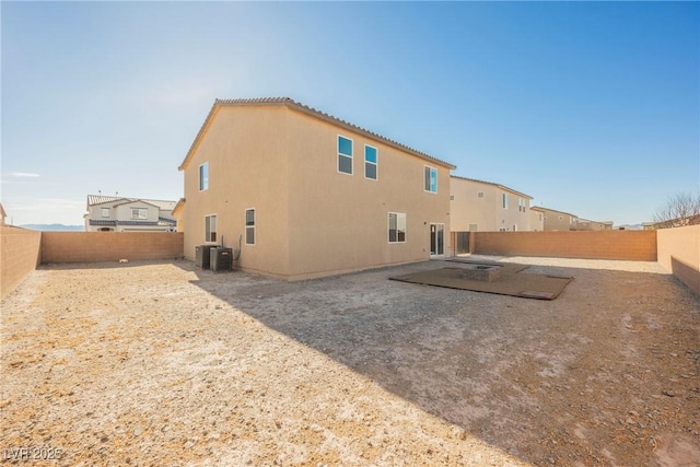 back of house with a patio and central AC unit