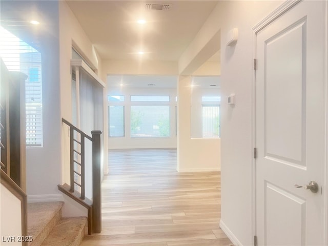 corridor with light hardwood / wood-style flooring