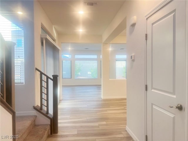 hallway featuring light hardwood / wood-style floors and a wealth of natural light