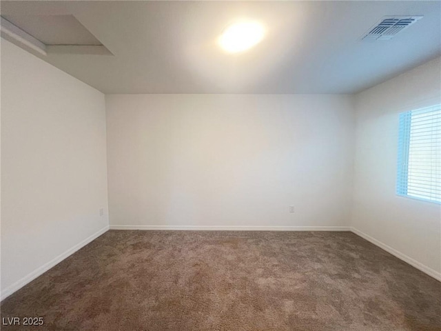 unfurnished room featuring dark colored carpet