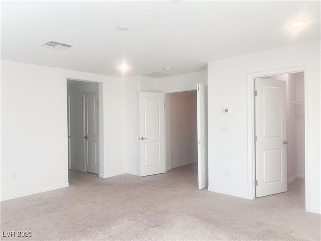 unfurnished room with light colored carpet