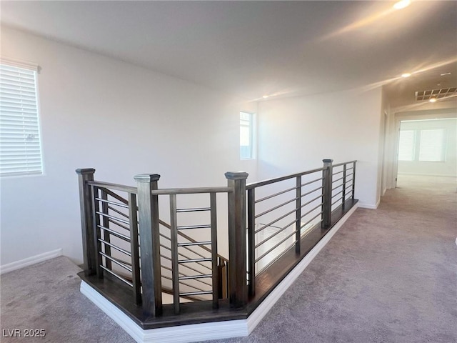 hallway featuring carpet flooring and a wealth of natural light