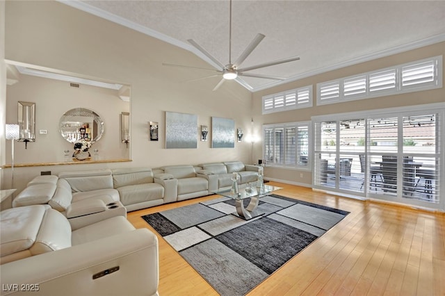 living room featuring crown molding, vaulted ceiling, ceiling fan, and light hardwood / wood-style flooring