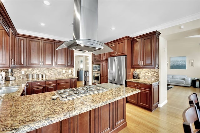 kitchen featuring light stone counters, appliances with stainless steel finishes, kitchen peninsula, and island range hood