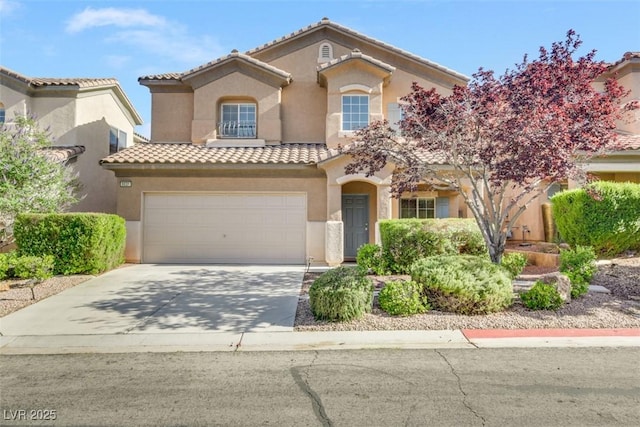 mediterranean / spanish-style home with a garage