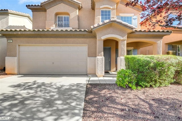 mediterranean / spanish-style home with a garage