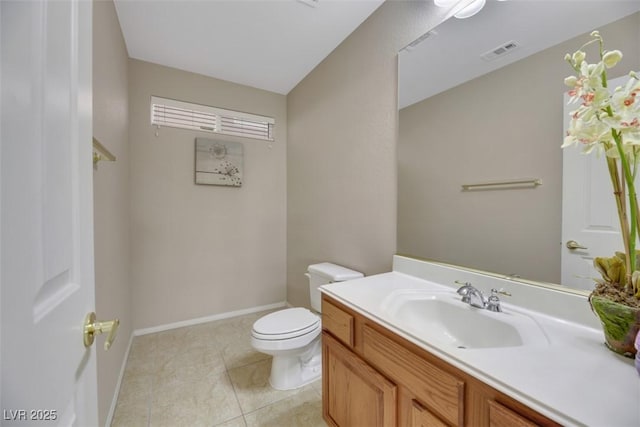 bathroom with tile patterned flooring, vanity, and toilet