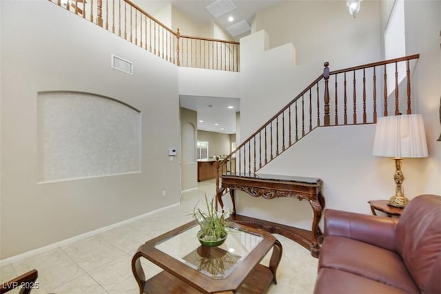 tiled living room with a high ceiling