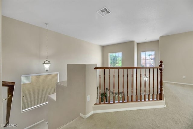 hallway featuring light carpet