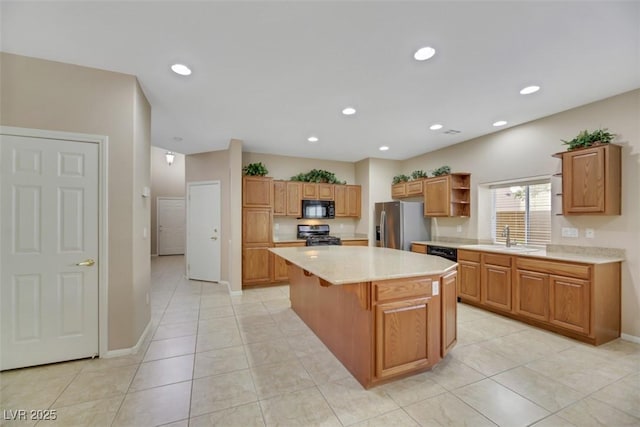 kitchen featuring light tile patterned floors, sink, a kitchen island, and black appliances