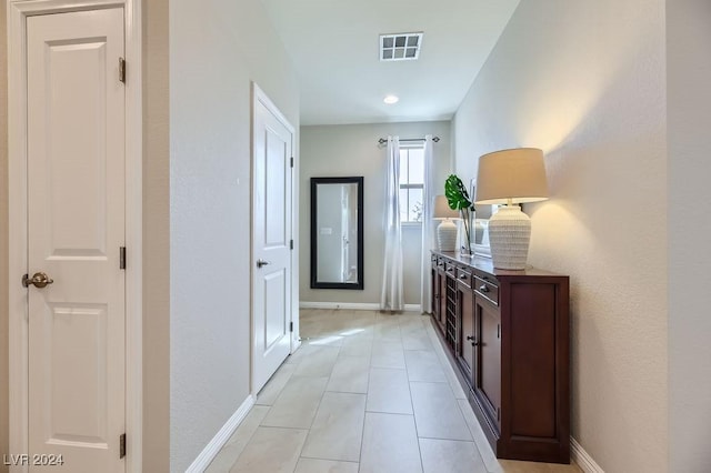 hall with light tile patterned flooring