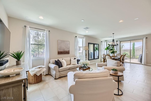 living room with a healthy amount of sunlight and an inviting chandelier