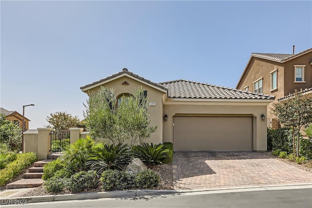 mediterranean / spanish house with a garage