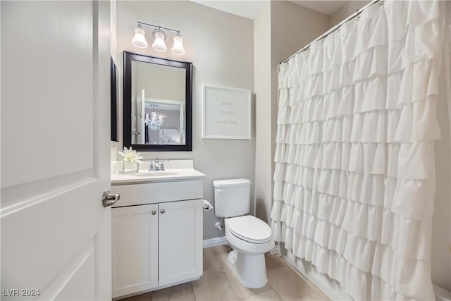 bathroom featuring tile patterned floors, vanity, toilet, and curtained shower