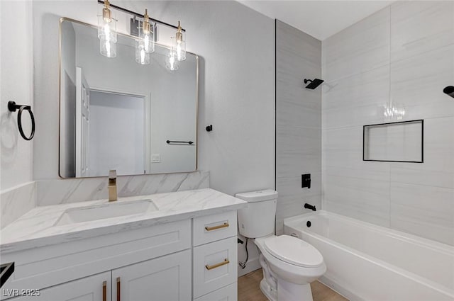 full bathroom featuring hardwood / wood-style flooring, vanity, shower / bathtub combination, and toilet