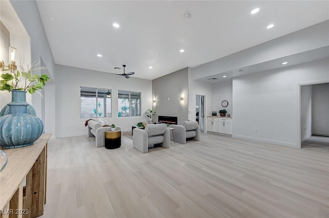 living room with ceiling fan and light wood-type flooring