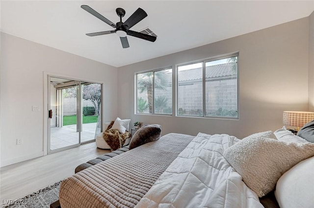 bedroom featuring access to outside, ceiling fan, and light wood-type flooring