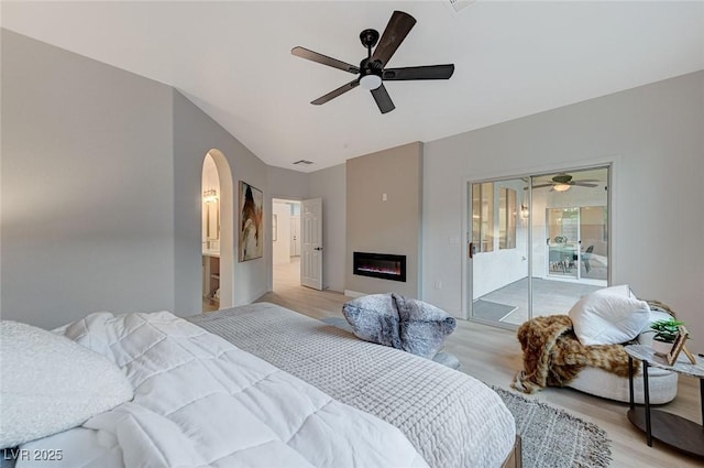 bedroom featuring ceiling fan, light hardwood / wood-style floors, and access to outside