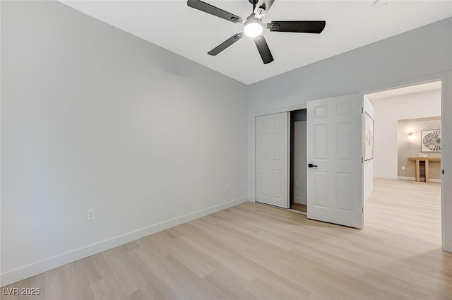 unfurnished bedroom featuring ceiling fan, a closet, and light wood-type flooring