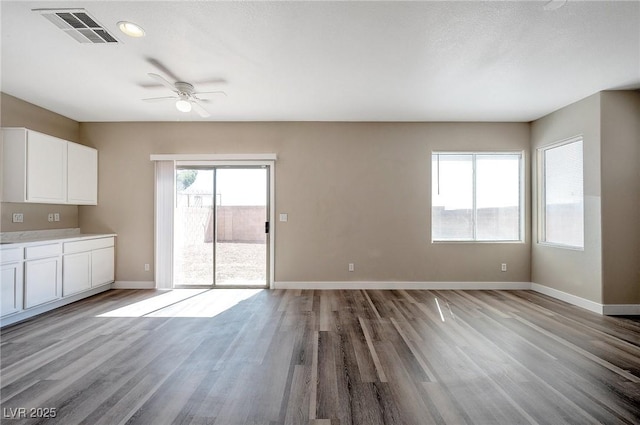 unfurnished living room featuring ceiling fan and light hardwood / wood-style floors