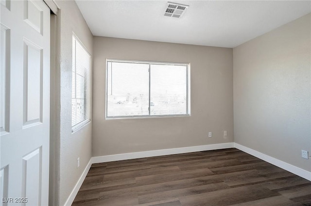 empty room featuring dark wood-type flooring